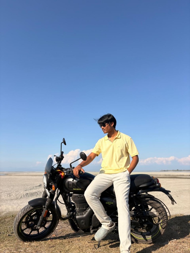 Mayur Bikash Gogoi (Mayur Bikash / Mayur Gogoi) outdoors on Royal Enfield Hunter 350 motorcycle in Assam, India